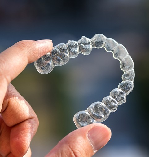 Patient placing Invisalign tray