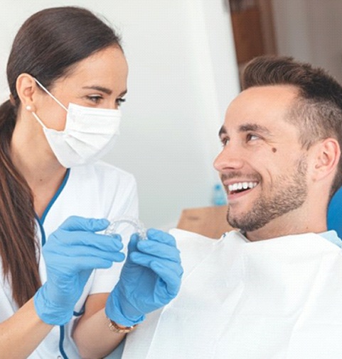 dentist and patient discussing the cost of Invisalign in Merrimack