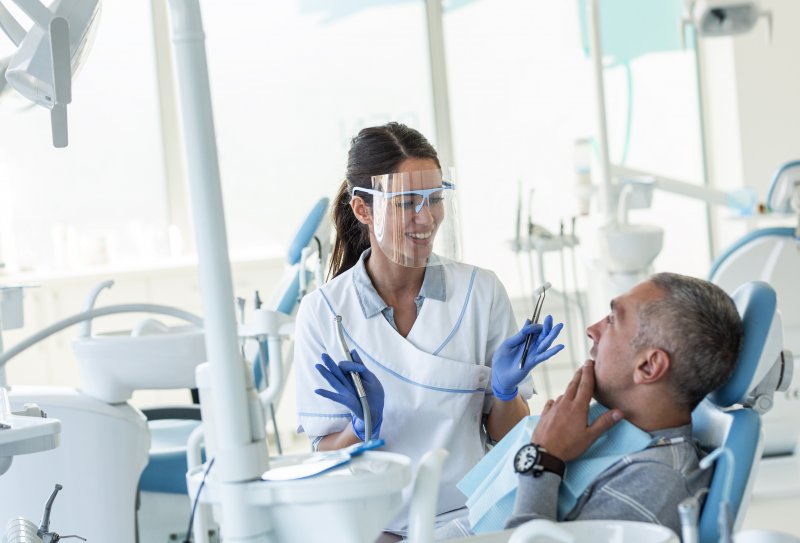 Dentist in Merrimack talking to patient
